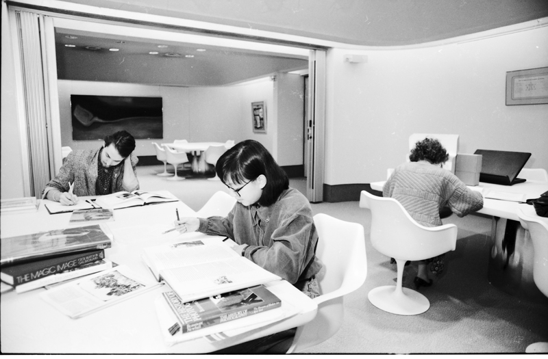Image of three researchers working in the reading room of the Clara Thomas Archives & Special Collections, York University Libraries. Image no. ASC05083.