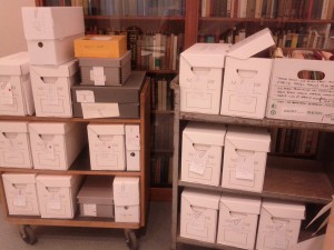 Two carts containing many boxes of archival material.