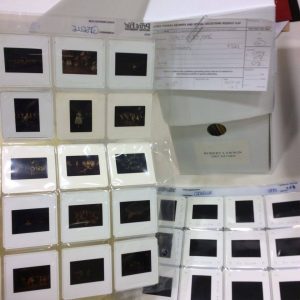 Image of a box with the label Robert Lawson surrounded by slides in plastic sheets.